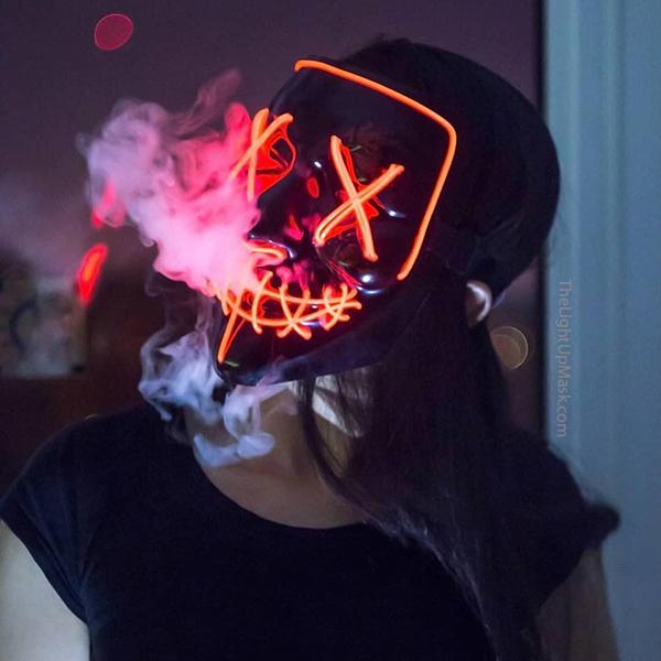 girl smoke with a orange led purge mask